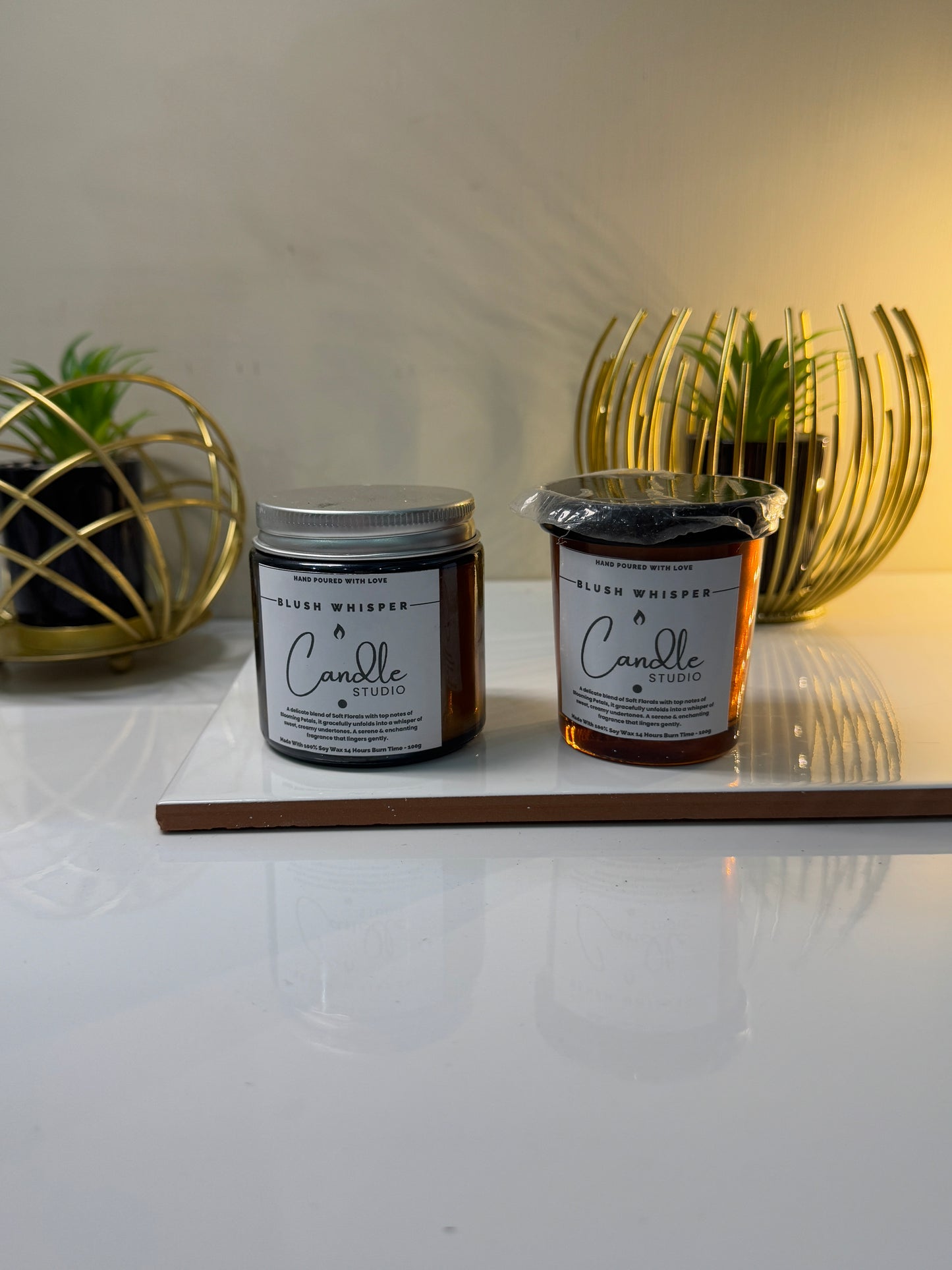 Unlit Blush Whisper candle in its jar, showcasing its soft blush color and elegant design.