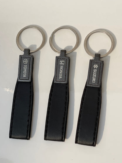 image of keychains with logo on honda, toyota, suzuki, premium quality in black color